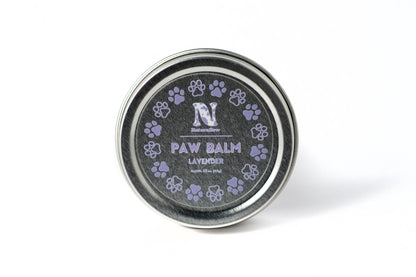 A photo of a small, circular tin with purple paw print illustrations. Its label reads "Naturallow Paw Balm Lavender. Net Weight 1.5 oz (42g)"
