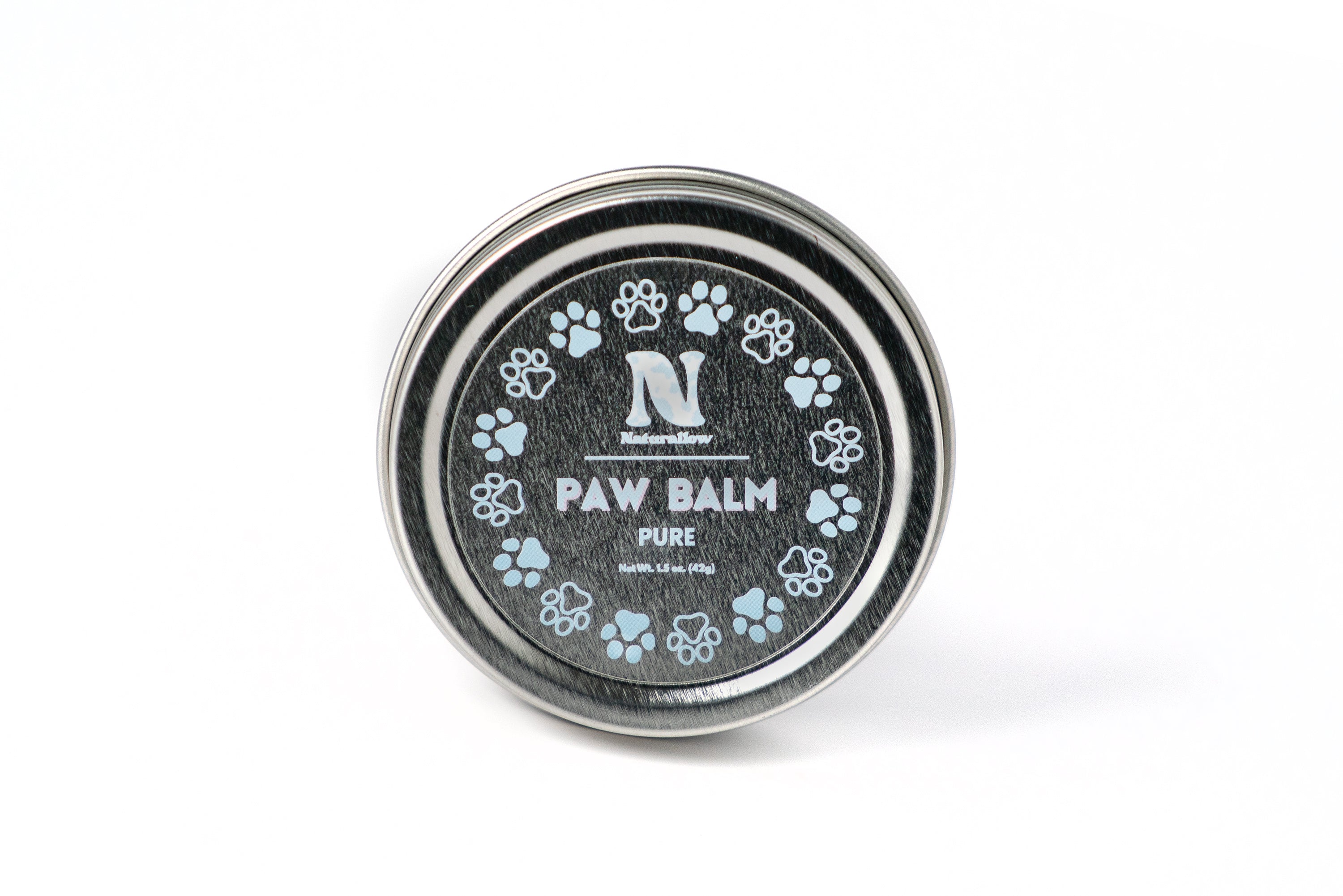 A photo of a small, circular tin with light blue paw print illustrations. Its label reads "Naturallow Paw Balm Pure. Net Weight 1.5 oz (42g)"